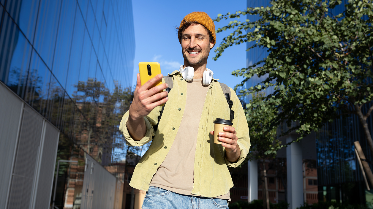 Young man smiling at phone