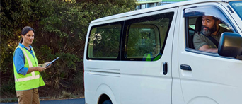 An NRMA Driving Instructor helping a student park their van