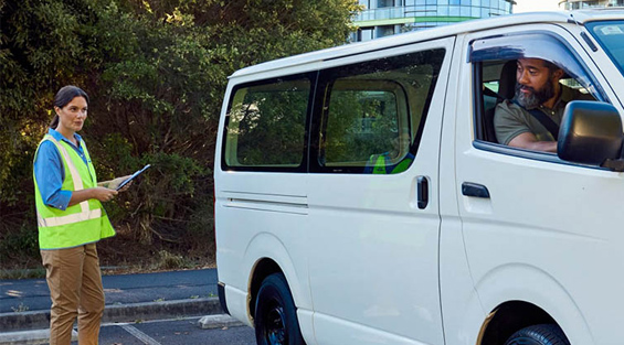 An NRMA Driving Instructor helping a student park their van