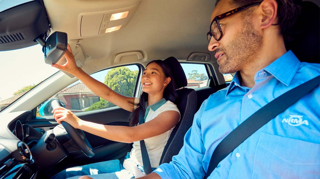 An NRMA Driving Instructor inside a car with a student