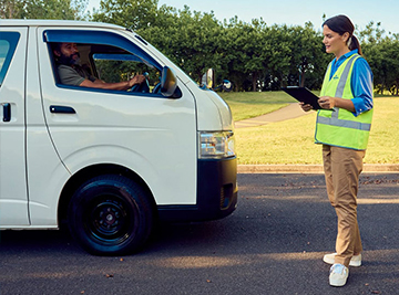 An NRMA Driving Instructor helping a student drive a van for business