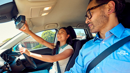 An NRMA Driving Instructor in the car with a student