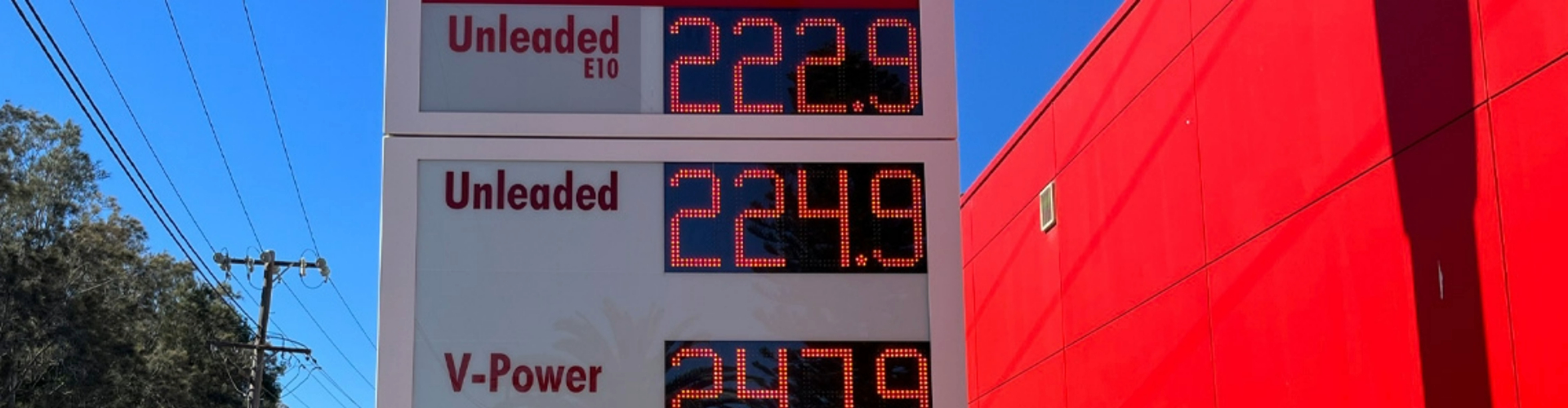 A digital sign showing fuel prices of Unleaded E10 at 222.9, Unleaded at 224.9 and V Power at 247.9.