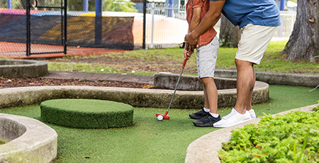 Family playing mini golf