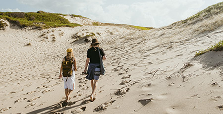 Stockton sand dunes people walking, credit: Destination NSW