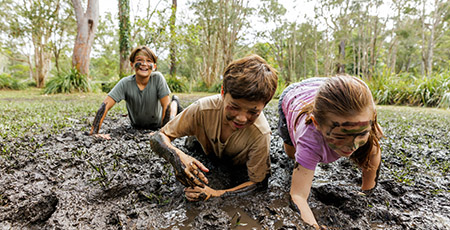Bear Grylls Survival Academy children in mud