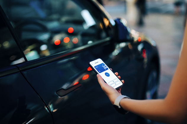 Woman using smartphone app to lock car