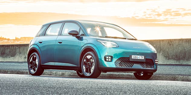 Blue electric hatch parked at sunset