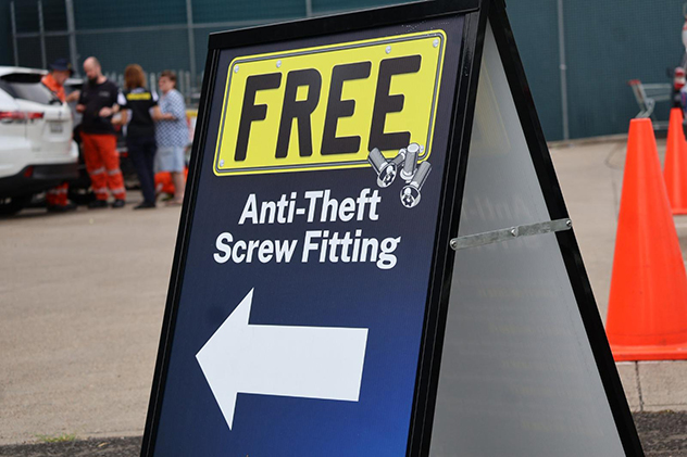 A sandwich board advertising free ant-theft screw fitting