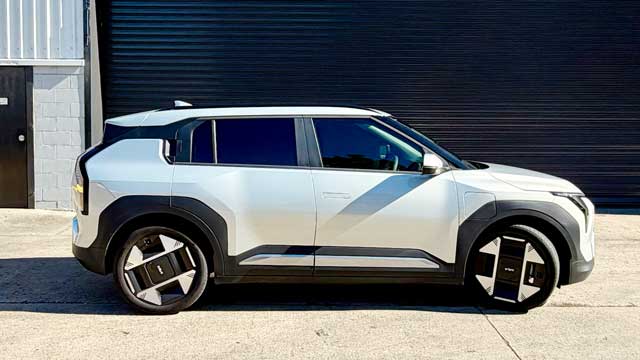 Kia EV3 side view in front of garage door