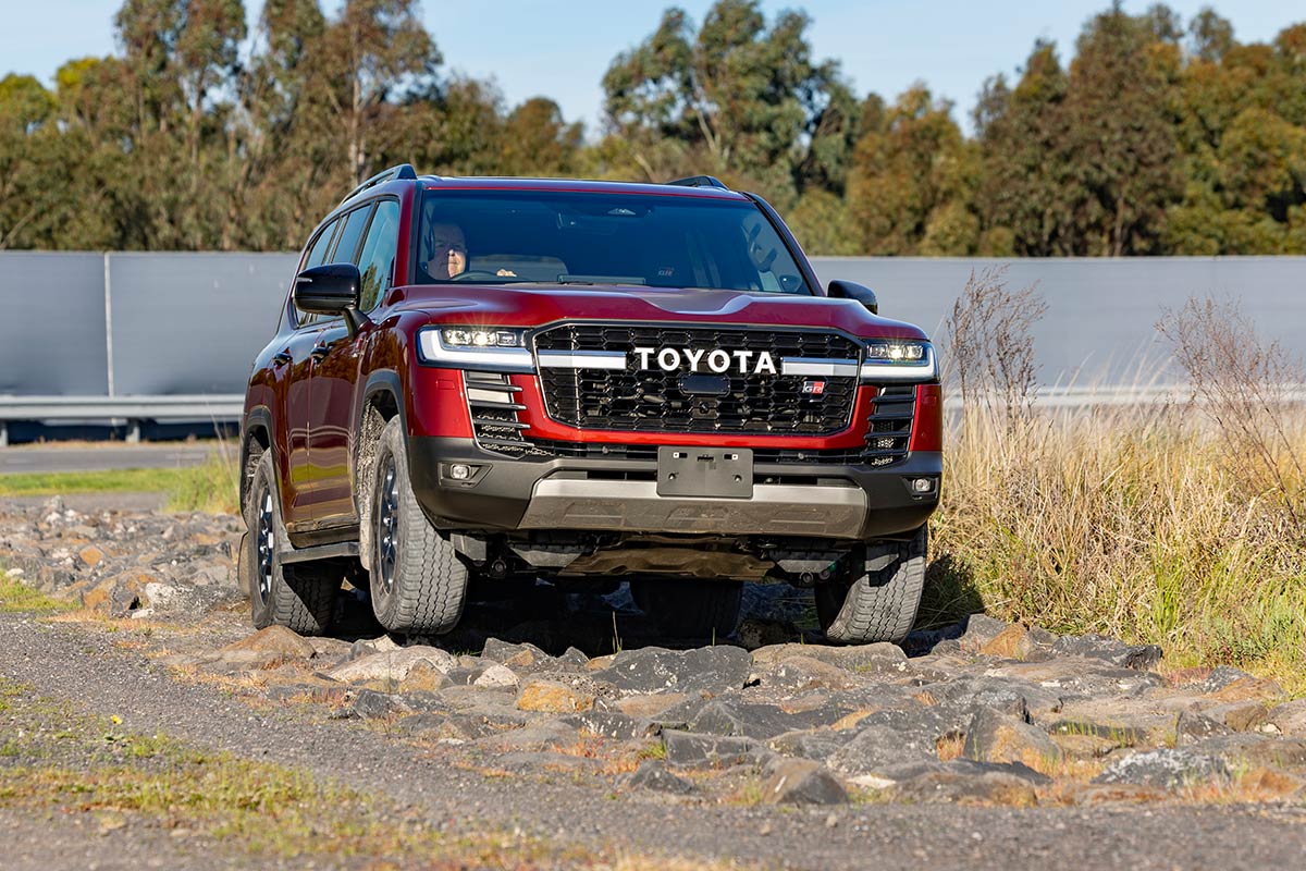 2026 Toyota Landcruiser 300 series driving on rocks