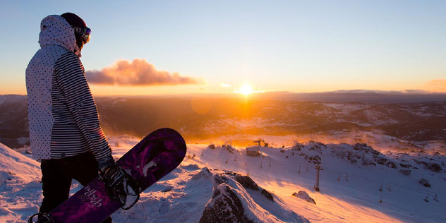 Snowboarder looking out over the snow field