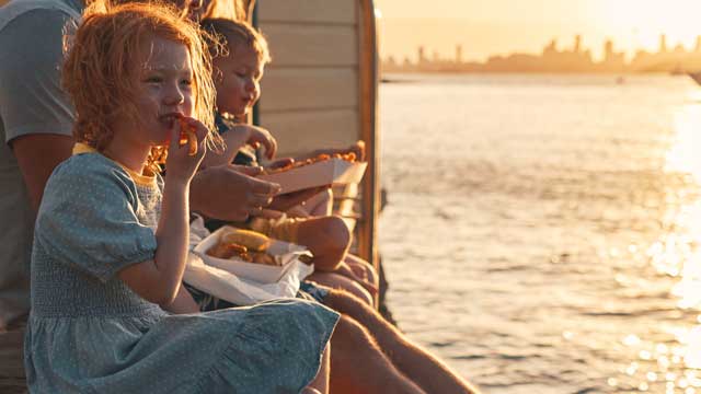 Camp Cove, Watsons Bay Family enjoying some food on the jetty at CampCove in Watsons Bay, Sydney