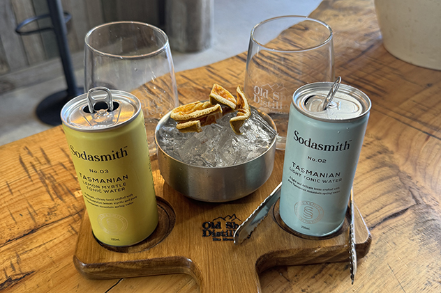 Two cans of tonic water on a paddle