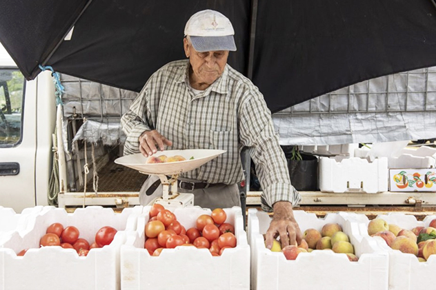 A man weighing vegetables