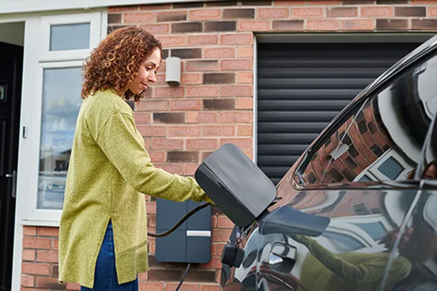 woman charging an ev at home