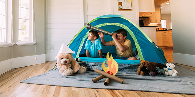 two boys in a tent indoors