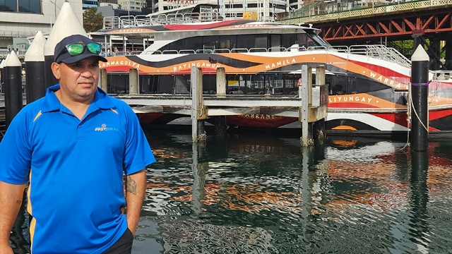 NRMA deckhand Thomas Wright standing on a dock with a boat in the background.