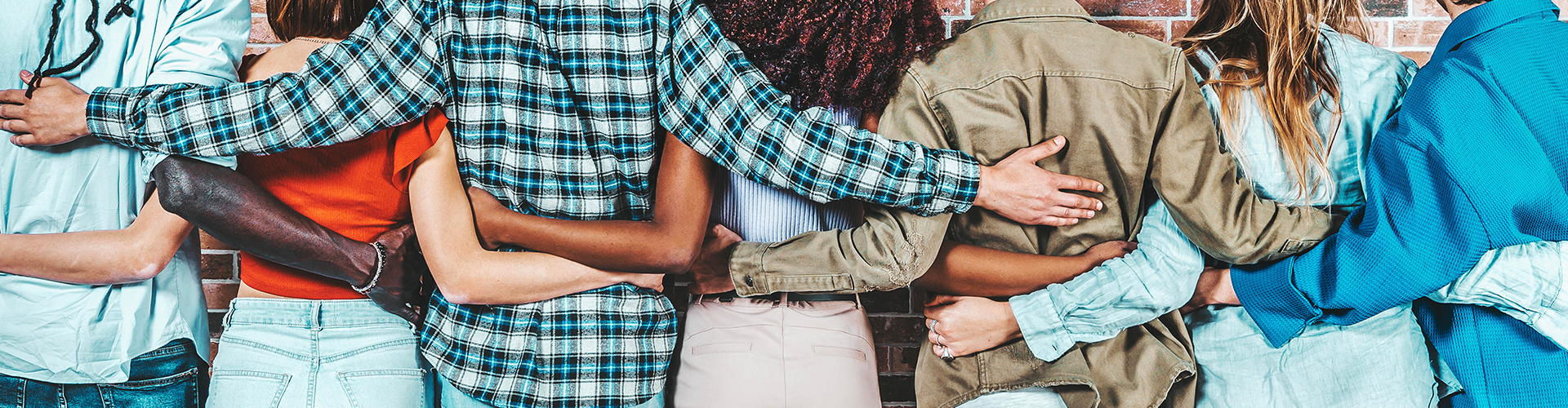 The backs of people hugging