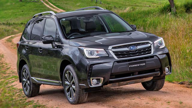 A black 2016 Subaru Forester XT Premium driving on a country road