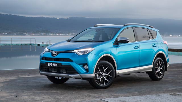 A blue 2016 Toyota Rav4 GX AWD parked in front of an ocean pool