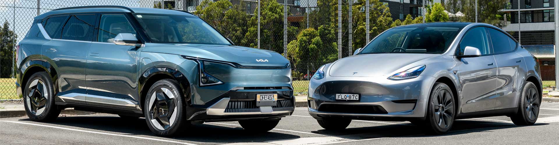 Tesla Model Y and Kia EV5 parked in apartment carpark