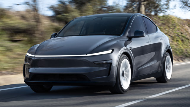 Grey Tesla Model Y driving on country road