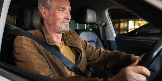60+ man driving car at night