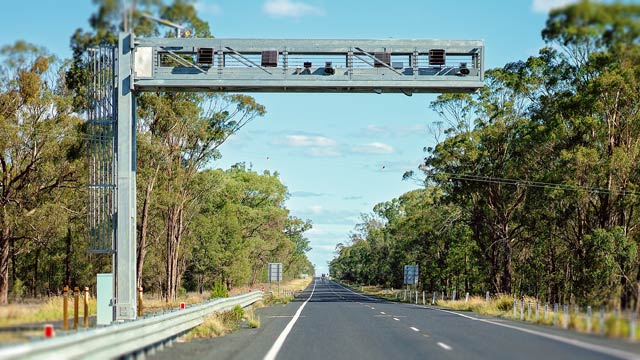 An average speed safety camera above a country road