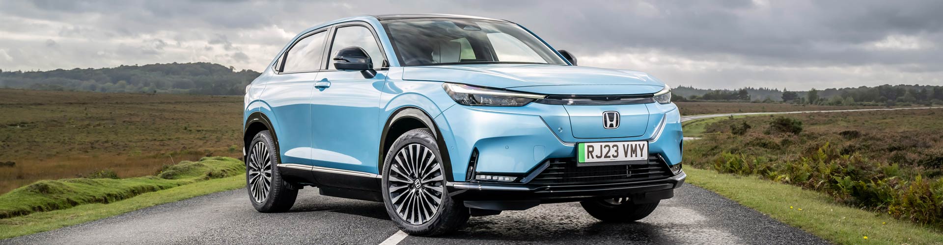 Blue Honda e:Ny1 parked on country road