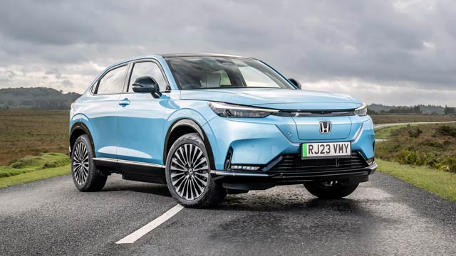 Blue Honda e:Ny1 parked on country road