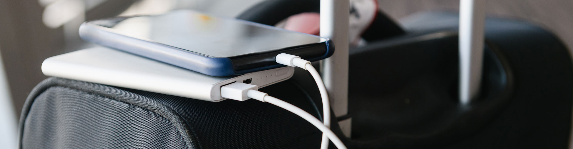 Phone and powerbank on luggage