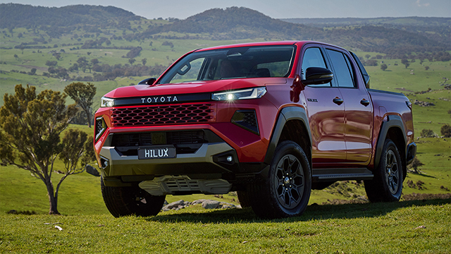 2026 Toyota HiLux on grassy hill.