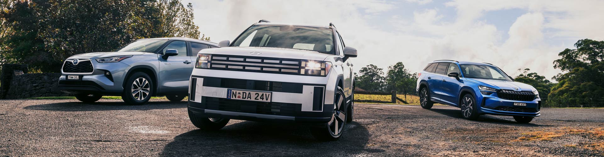 2025 Skoda Kodiaq, Hyundai Santa Fe and Toyota Kluger parked on gravel