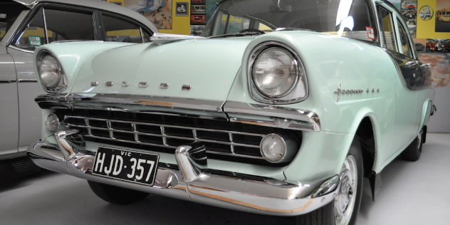 Front view of a mint green 1960 FB-EK Holden parked on a showroom floor. 