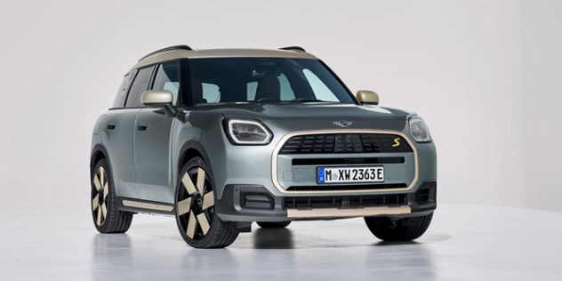 A silver/gray 2024 Mini Countryman parked against a white background