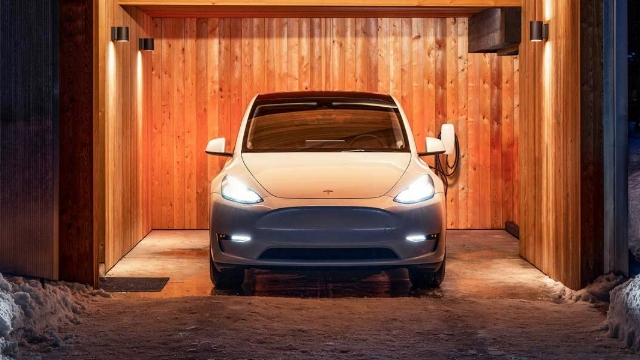 A white Tesla parked in a covered space with wooden paneling.