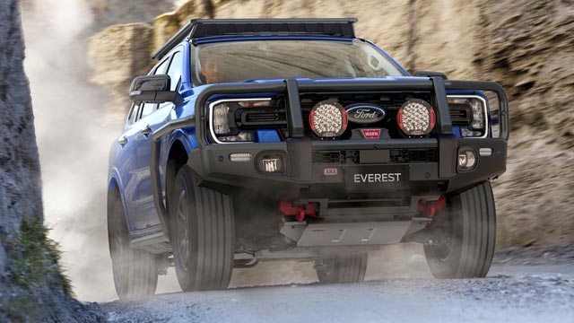A ute with bull bars on the front drives through a rocky chasm