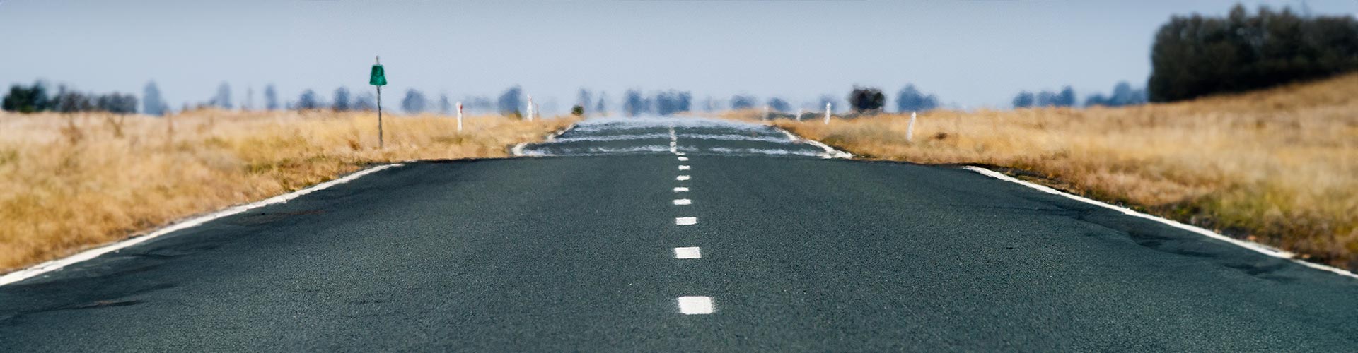 Low angle of haze rising from a road on a searing hot day