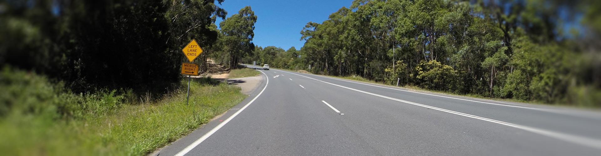 A left lane ends on a dual carriage country road
