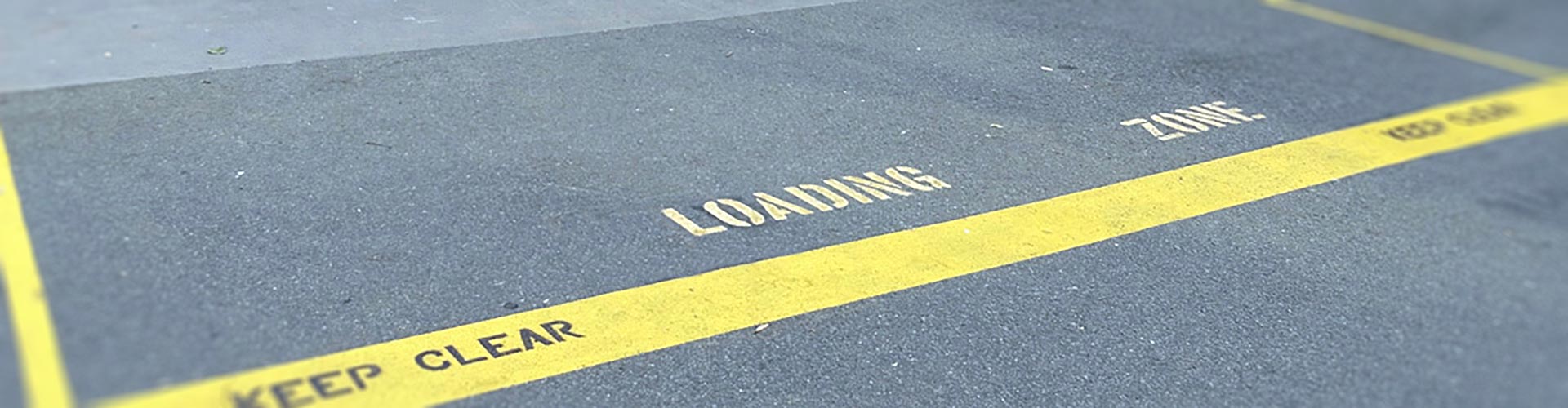 Yellow loading zone markings in a car park