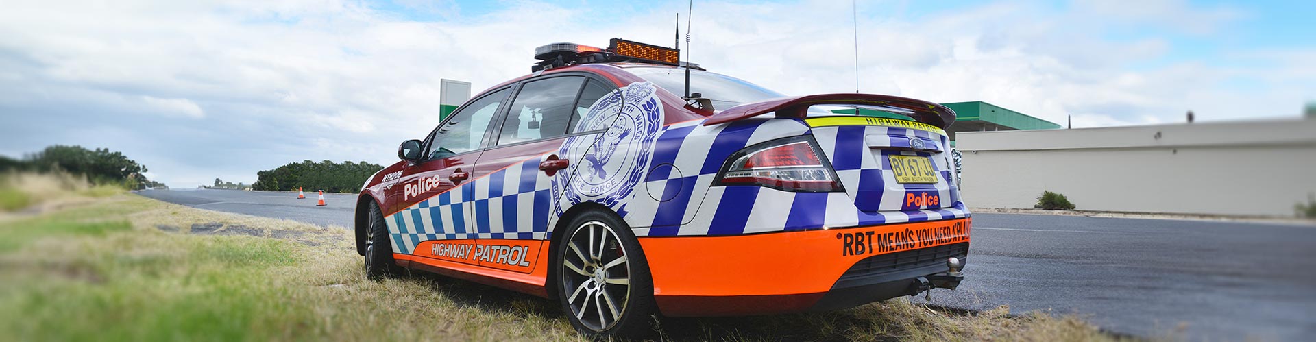 A random breath testing police car sits by the side of the road