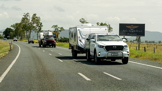 Cars towing caravans on a highway