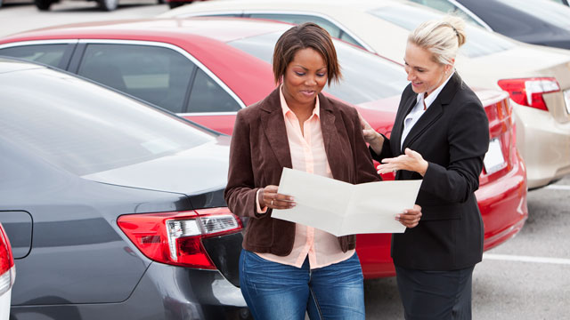Two women discuss car lease