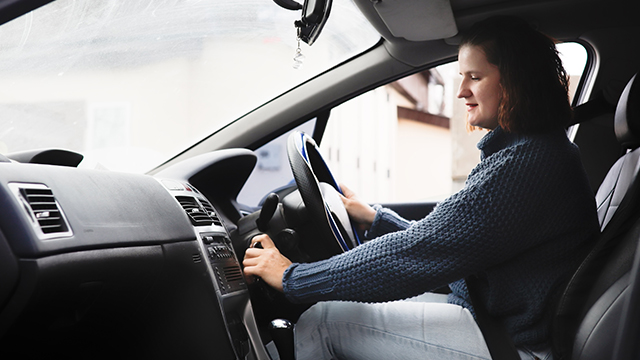 Woman starting a car