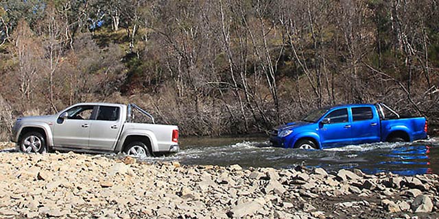 Blue 2011 Toyota Hilux and silver VW Amarok