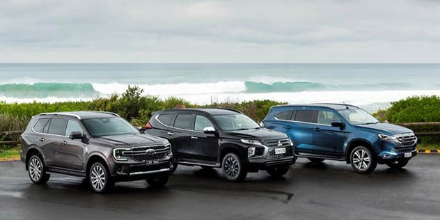 Ford Everest Rugged and Isuzu MU-X and Mitsubishi Pajero lined up in front of beach