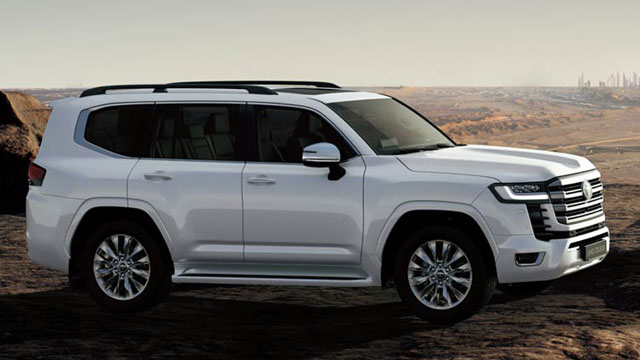 White 2022 Toyota Land Cruiser parked on rocky outcrop at sunset