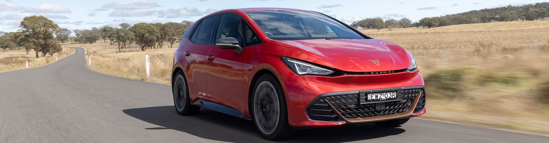 Red 2023 Cupra Born on country road