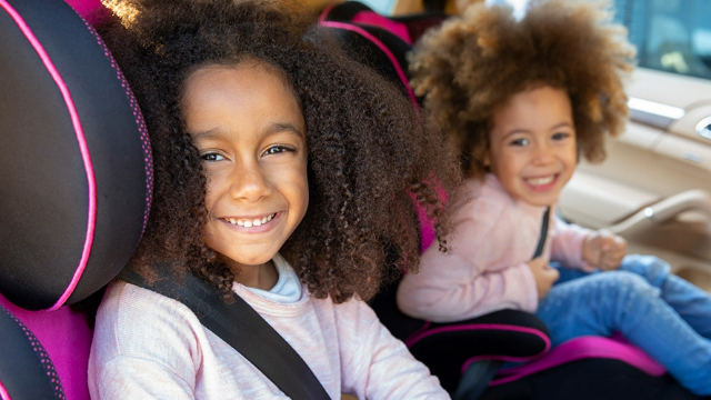 Two girls sitting in child car seats